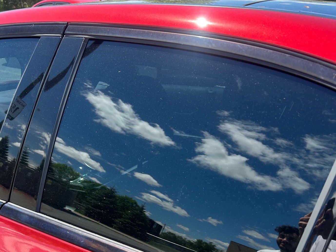 Dark ceramic window tint on a Red sedan in Ottawa