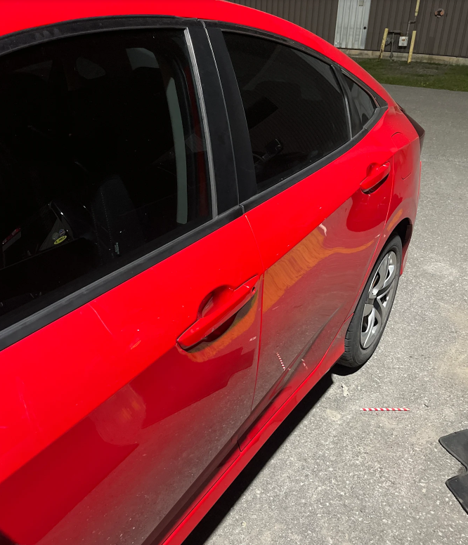 Red sedan with dark ceramic window tint installed by AutoWa Customs